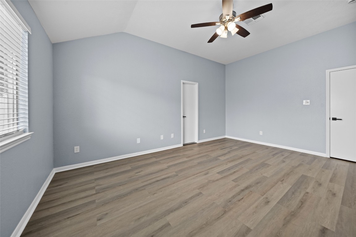 6627 Greenhouse Road Katy, TX 77449 - Photo 11 of 23 wooden floor in an empty room with a window