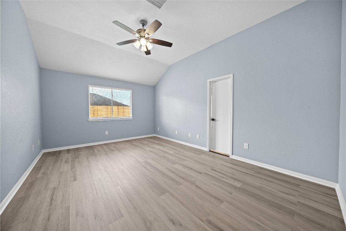 6627 Greenhouse Road Katy, TX 77449 - Photo 13 of 23 wooden floor in an empty room with a window
