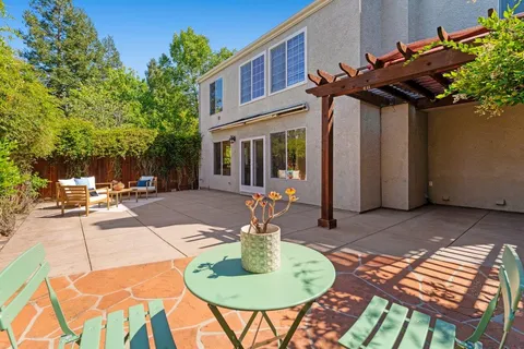 a backyard of a house with a table and chairs
