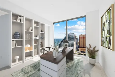 a living room with furniture kitchen view and a flat screen tv