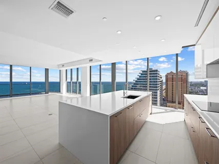 a large kitchen with kitchen island a large window a sink and counter space