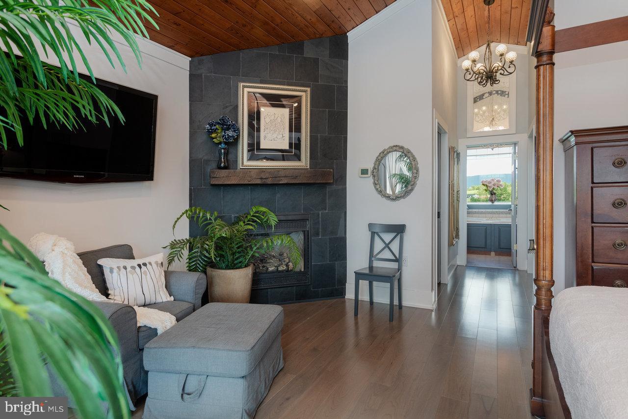 1934 Quicksburg Road Quicksburg, VA 22847 - Photo 50 of 103 a living room with furniture a flat screen tv and a fireplace