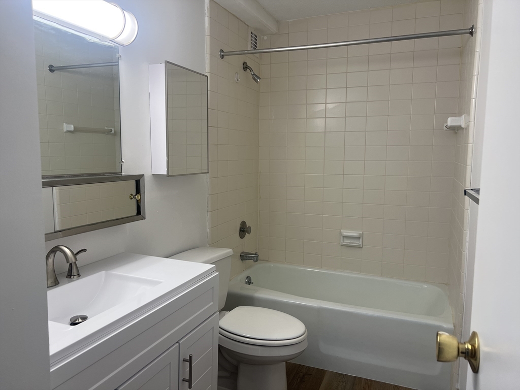 1 Pond Street, Unit 4N Winthrop, MA 02152 - Photo 7 of 13 a bathroom with a sink a toilet and shower