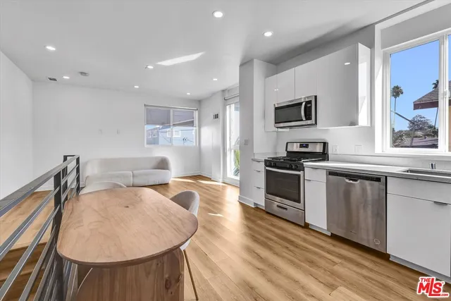 a large white kitchen with sink stove and refrigerator