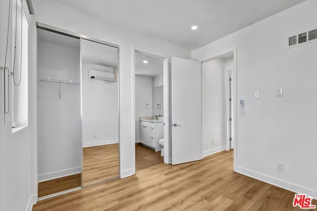 a view of wooden floor and windows in a room