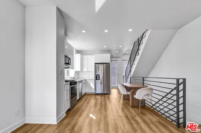 a view of a kitchen with a sink and refrigerator