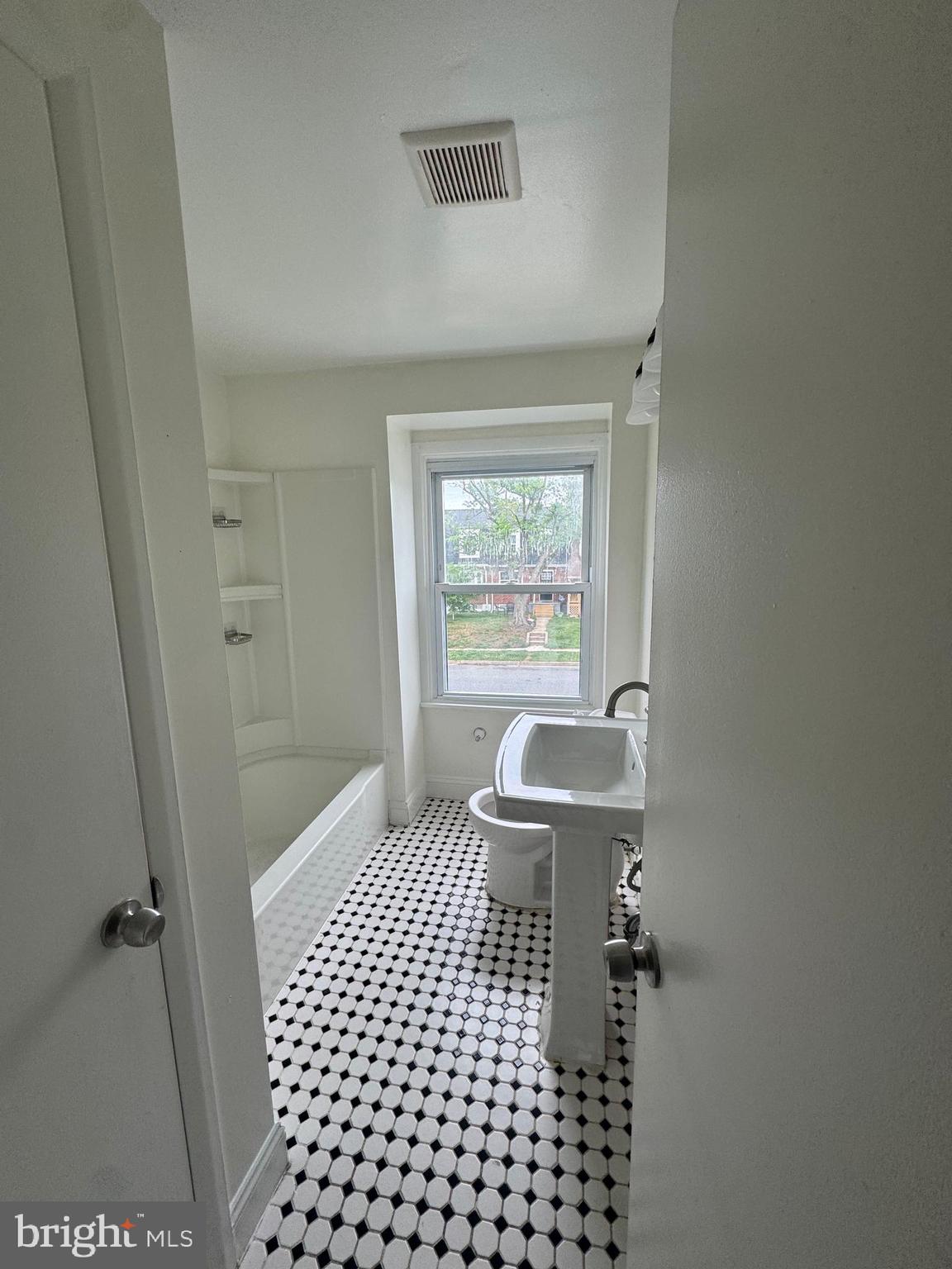 2128 Cockspur Road Middle River, MD 21220 - Photo 20 of 28 a bathroom with a sink a toilet a window and vanity