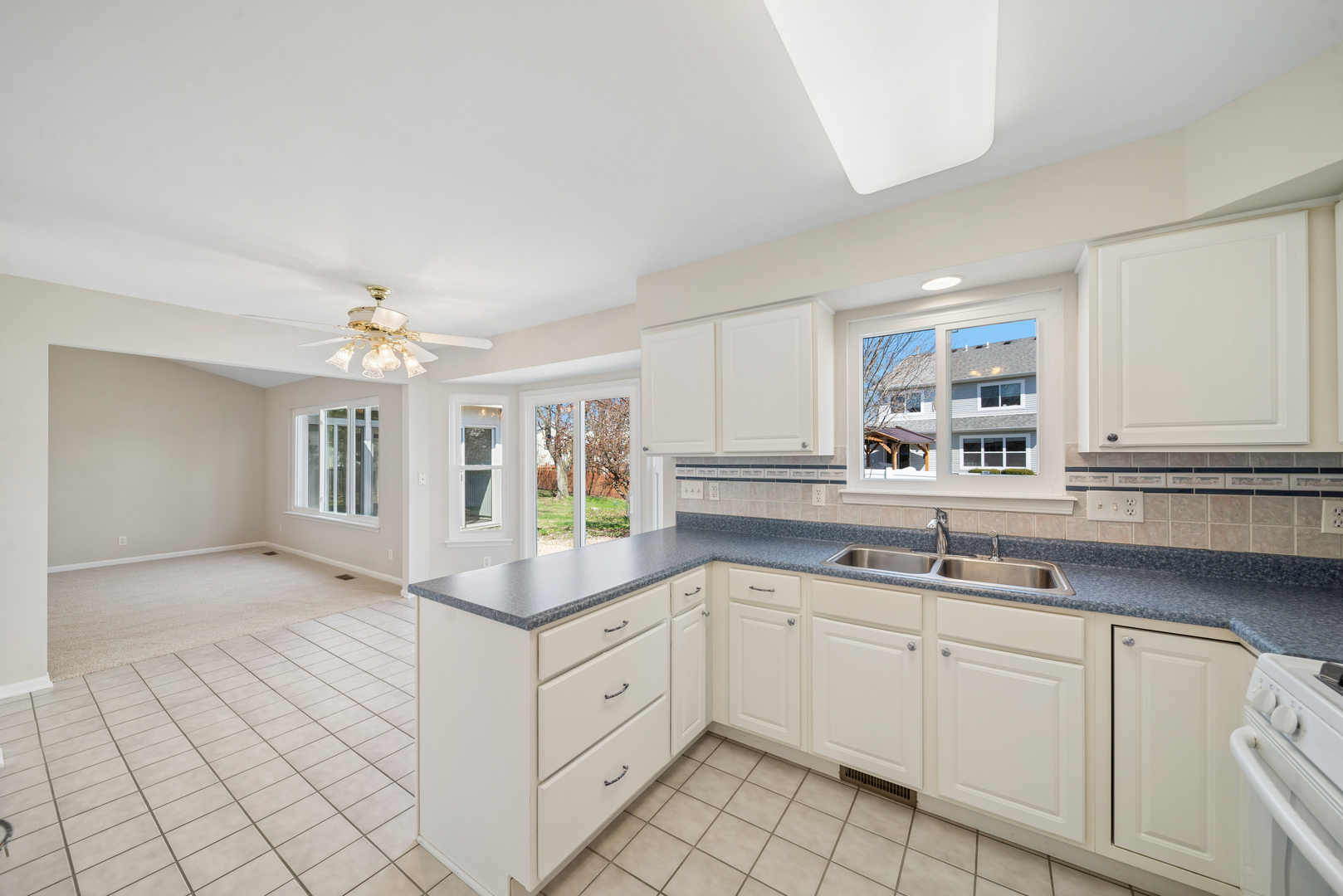 233 Spring Court North Aurora, IL 60542 - Photo 13 of 18 a kitchen with a sink cabinets and window