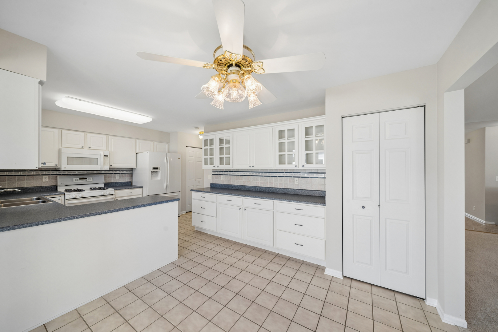 233 Spring Court North Aurora, IL 60542 - Photo 15 of 18 a kitchen with stainless steel appliances a sink stove and cabinets