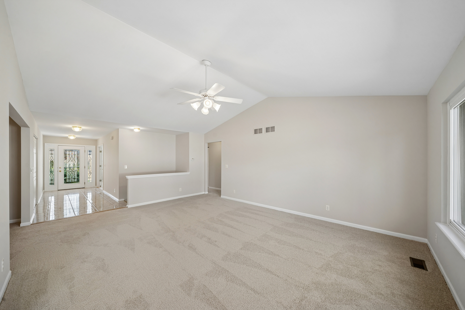 233 Spring Court North Aurora, IL 60542 - Photo 16 of 18 an empty room with chandelier fan and windows