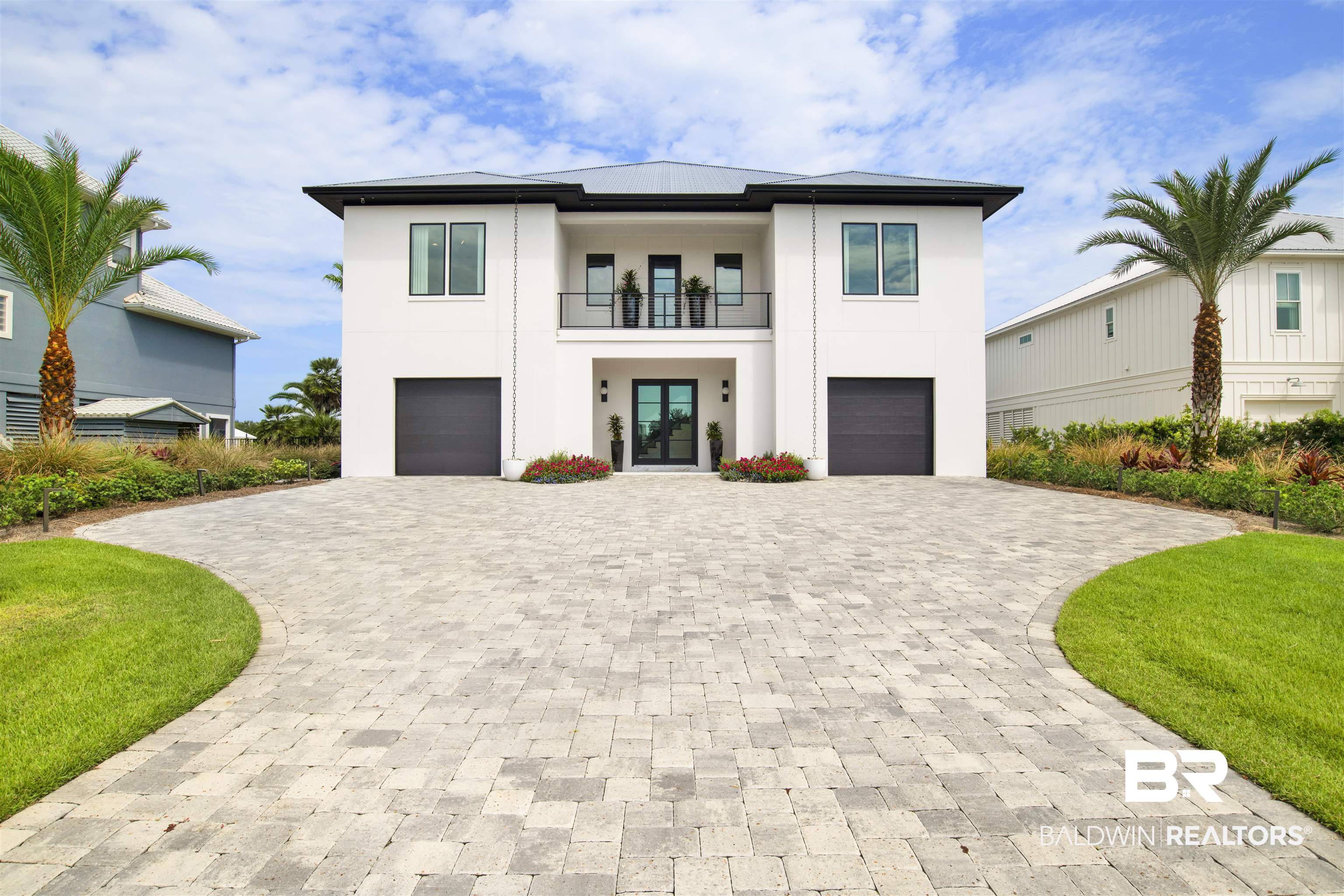 30239 Canal Court Orange Beach, AL 36561 - Photo 1 of 70 Modern home with stucco siding, a balcony, decorative driveway, and french doors
