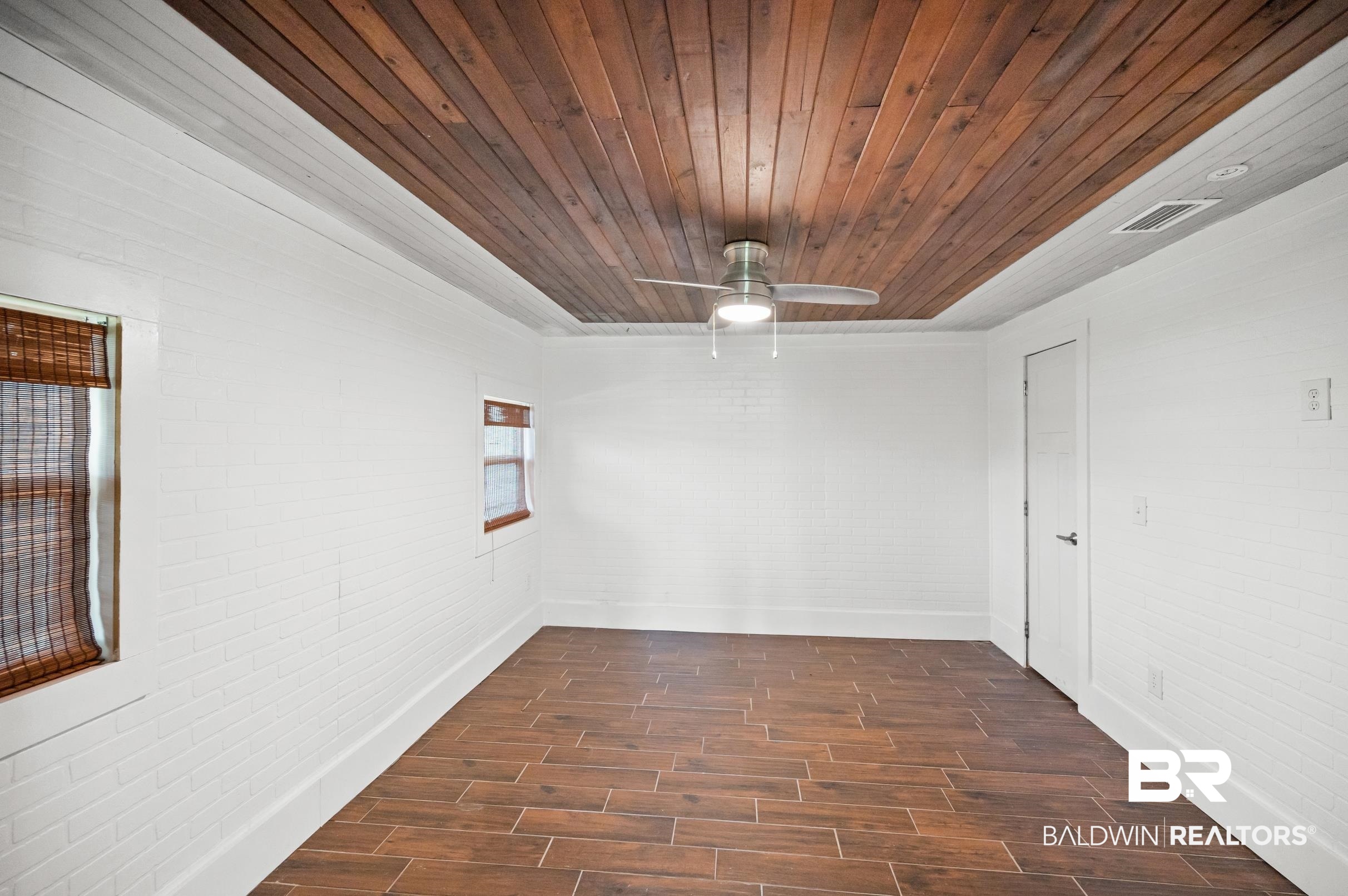 24663 Chestnut Street Elberta, AL 36530 - Photo 19 of 22 Recessed wood panel ceiling with a contemporary ceiling fan and light fixture