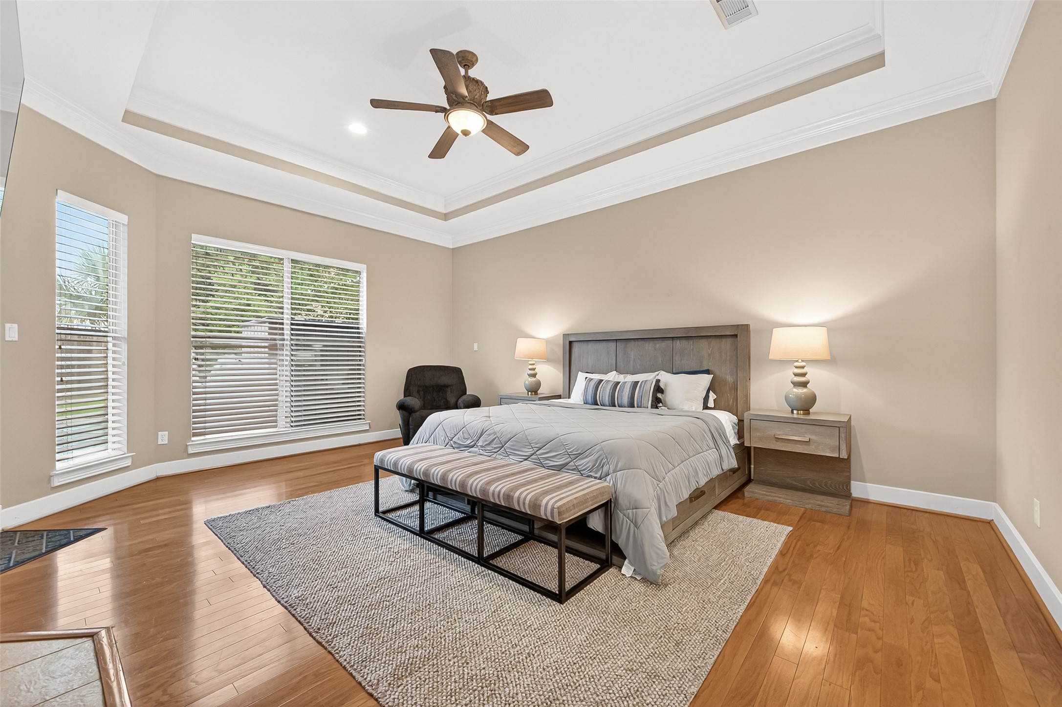 22 Stonegate Park Court Spring, TX 77379 - Photo 22 of 49 View of the primary suite featuring wood floors and a trey ceiling for added detail.