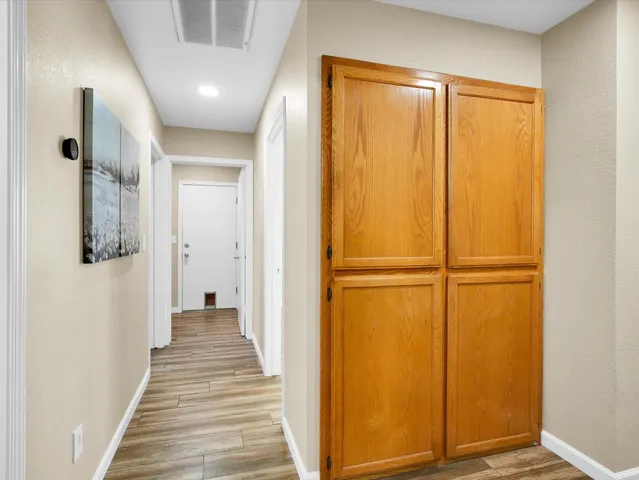 a view of a hallway with wooden floor