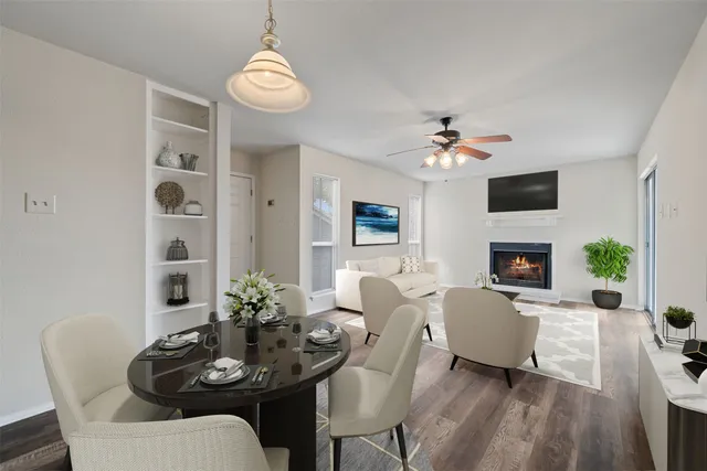a living room with furniture a fireplace and a chandelier