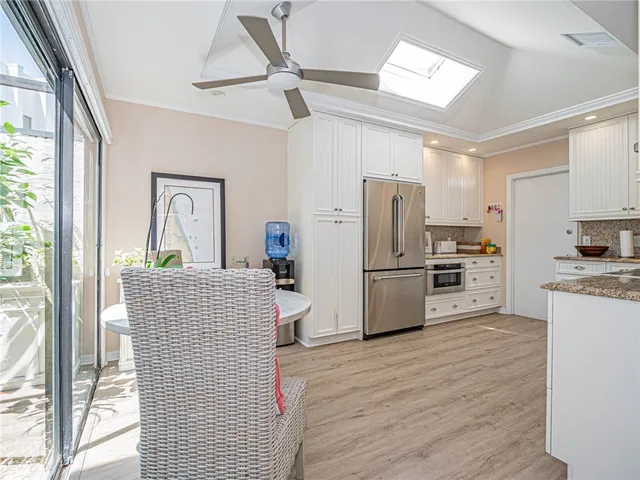 a kitchen with refrigerator cabinets and a sink