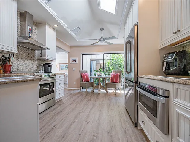 a kitchen with a stove a sink and a refrigerator