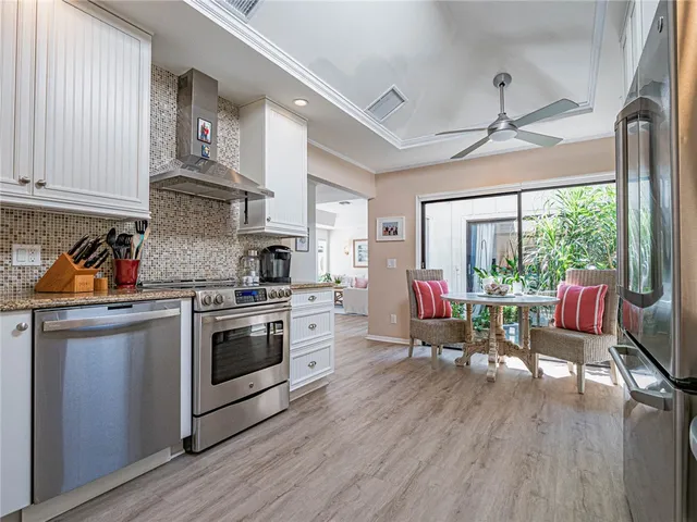 a kitchen with stainless steel appliances granite countertop a stove and wooden floor