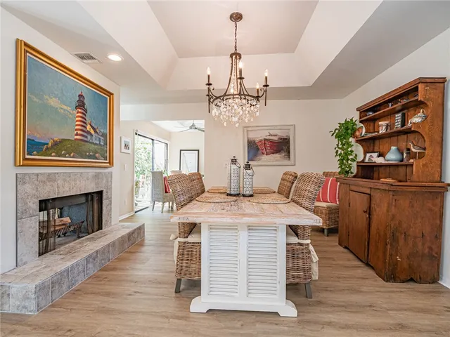 a view of a dining room with furniture wooden floor and a chandelier