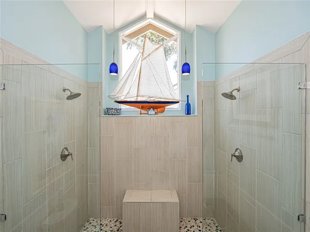 a bathroom with a window and a shower