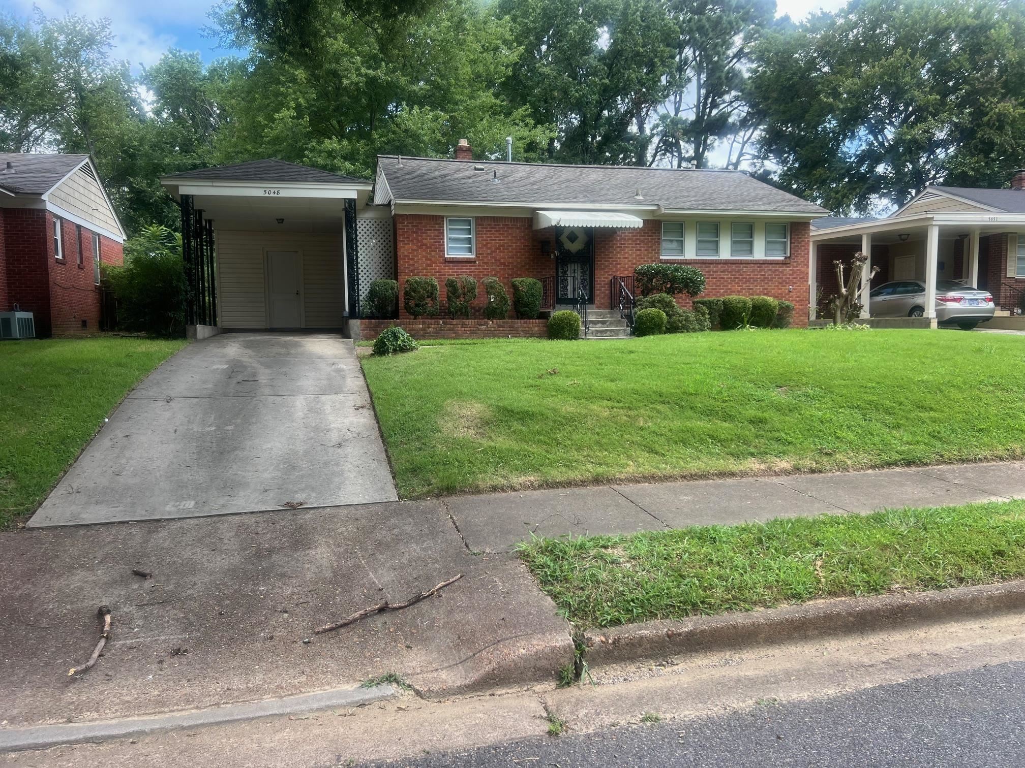 5048 Kaye Road Memphis, TN 38117 - Photo 1 of 19 front view of a house and a yard