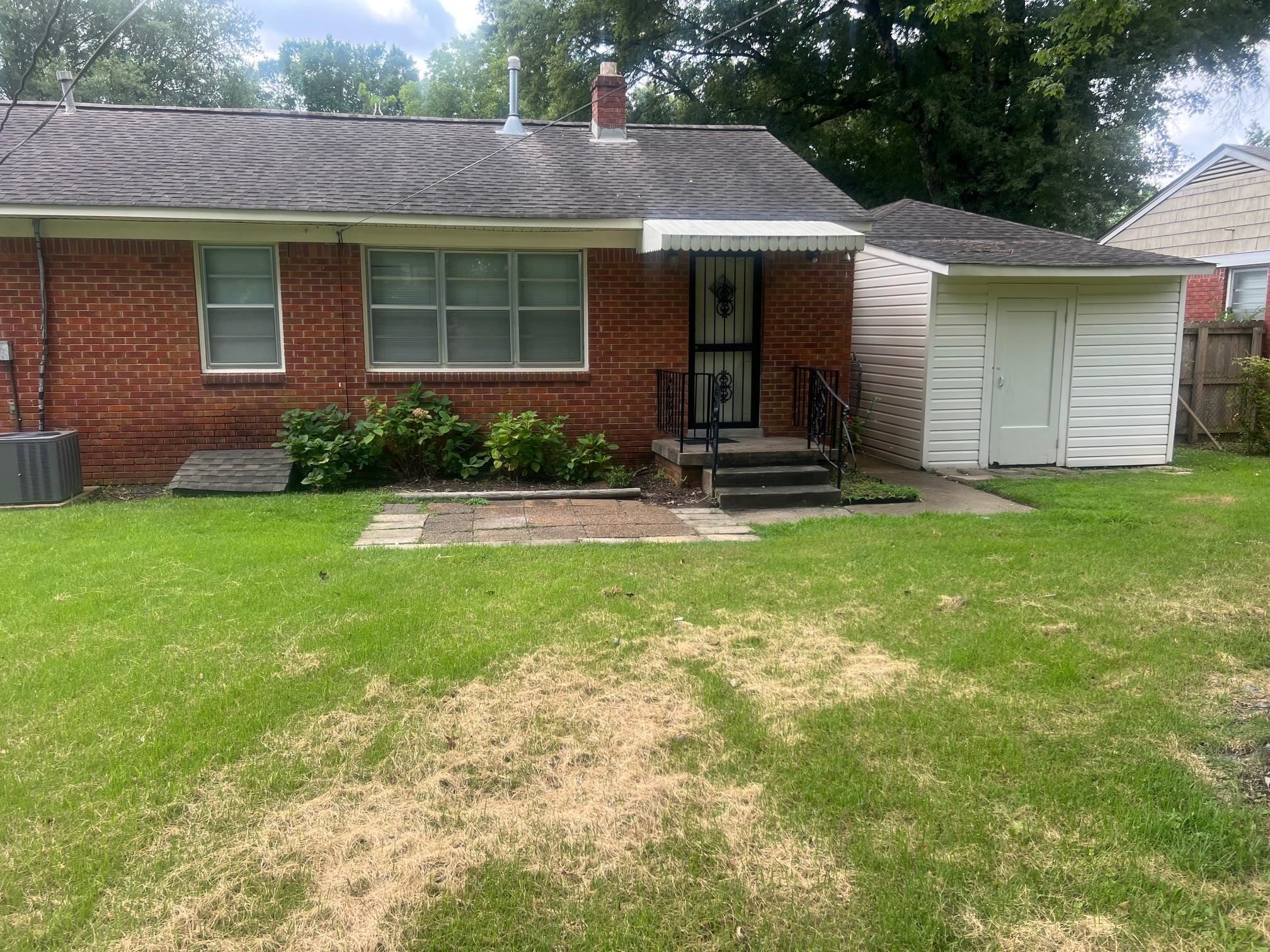 5048 Kaye Road Memphis, TN 38117 - Photo 17 of 19 a front view of a house with garden and porch
