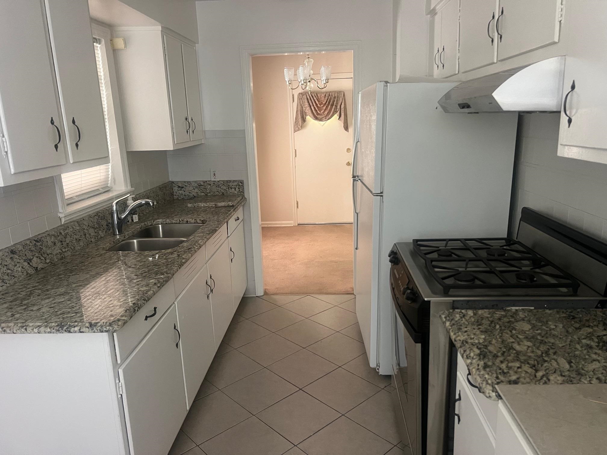 5048 Kaye Road Memphis, TN 38117 - Photo 4 of 19 a kitchen with granite countertop stainless steel appliances a sink stove and cabinets