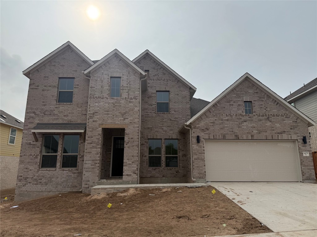 1409 Amanda Paige Drive Georgetown, TX 78628 - Photo 1 of 1 a front view of a house with a garden and yard