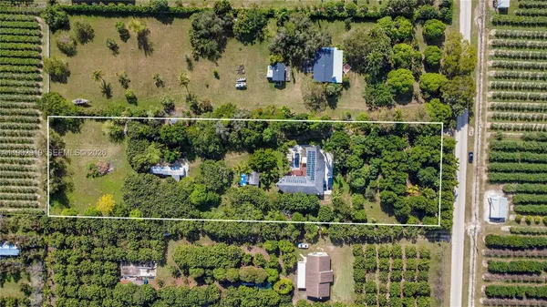 an aerial view of a residential houses with outdoor space