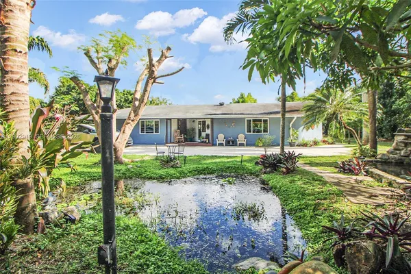 a view of a garden with large trees