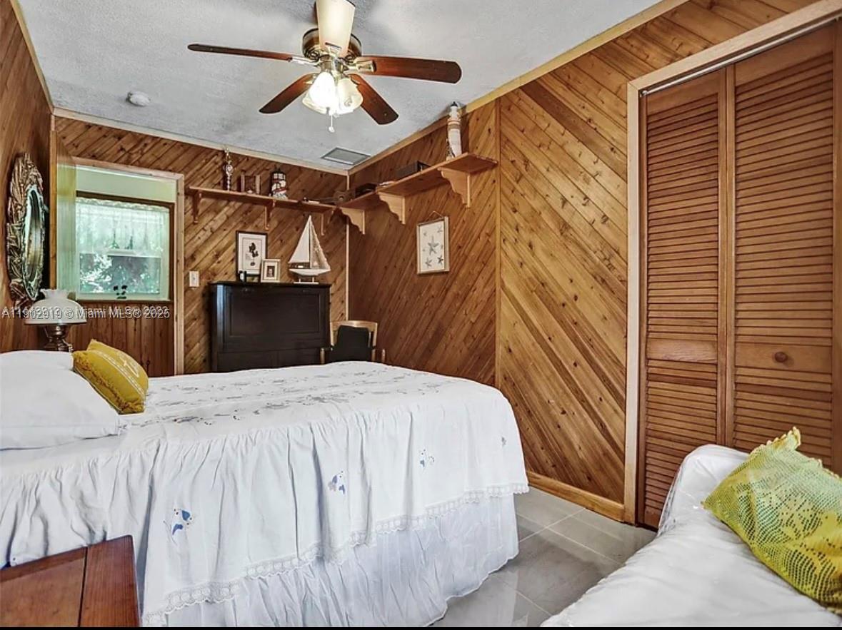 37225 Southwest 214th Avenue Homestead, FL 33034 - Photo 16 of 75 a bedroom with a bed dresser and a window