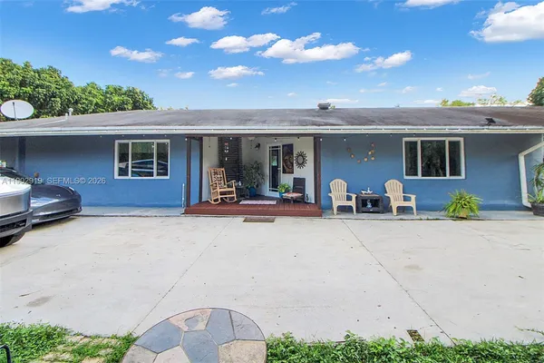 a backyard of a house with a tree