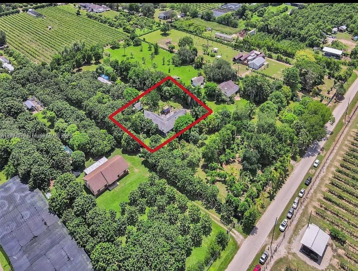 37225 Southwest 214th Avenue Homestead, FL 33034 - Photo 23 of 75 an aerial view of residential house with outdoor space and trees all around