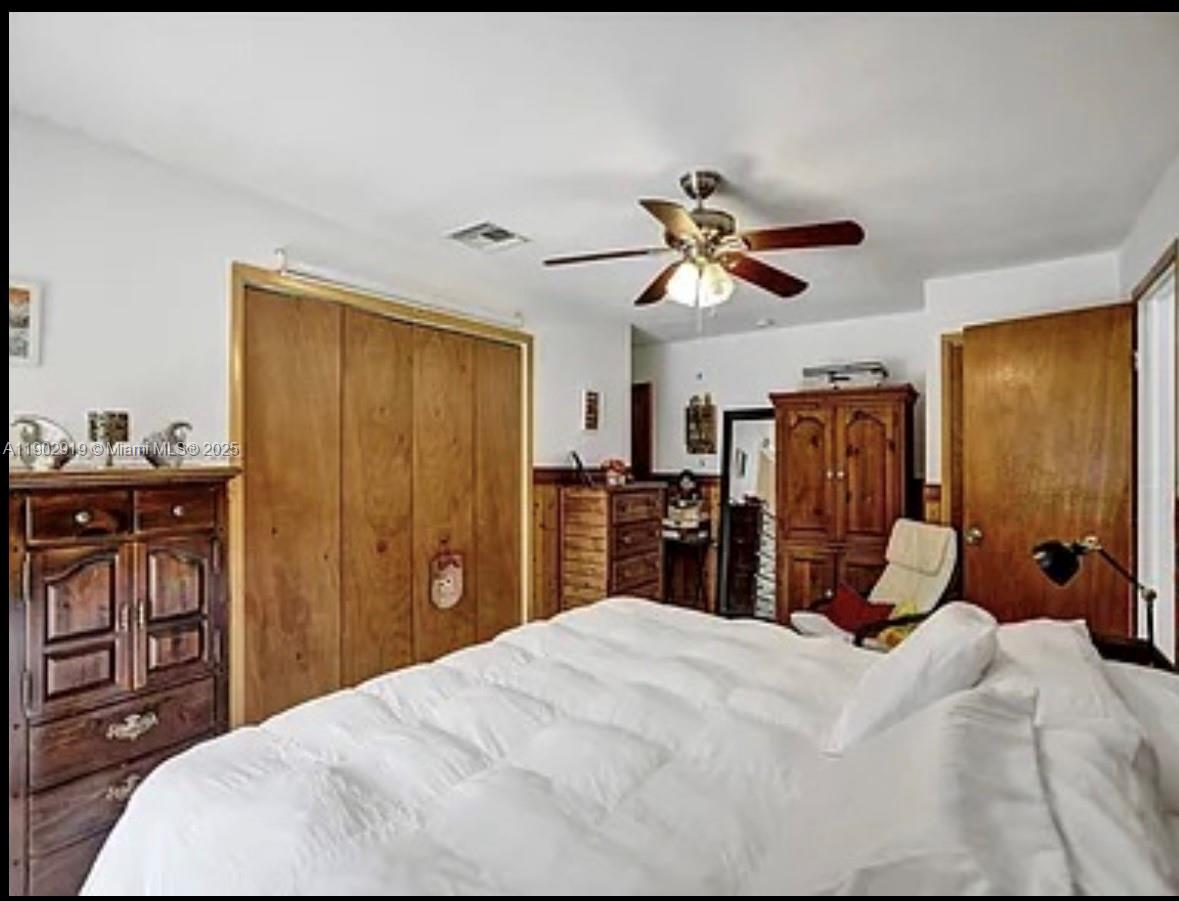 37225 Southwest 214th Avenue Homestead, FL 33034 - Photo 25 of 75 a bedroom with a bed and a chandelier
