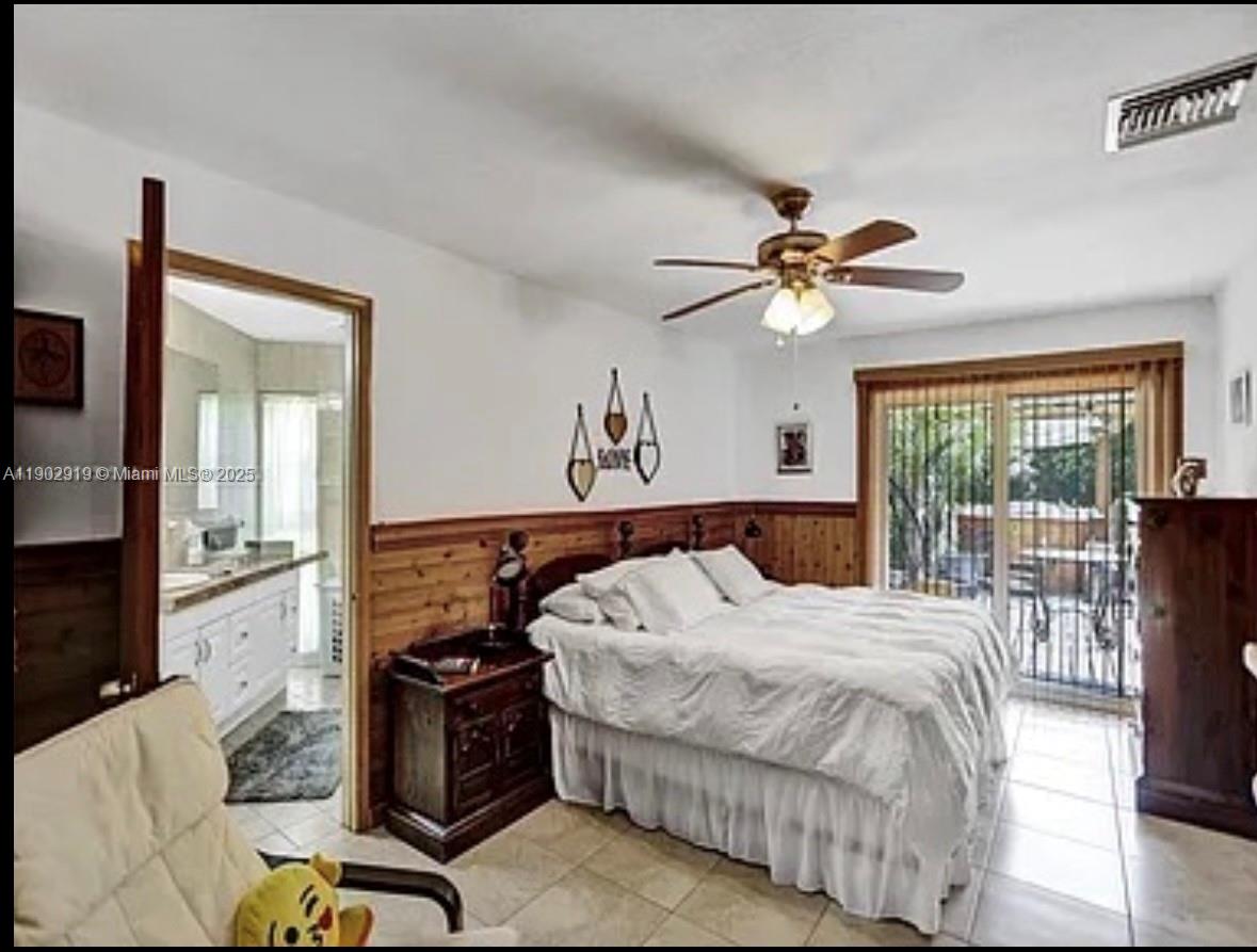 37225 Southwest 214th Avenue Homestead, FL 33034 - Photo 27 of 75 a bedroom with a bed and a chandelier