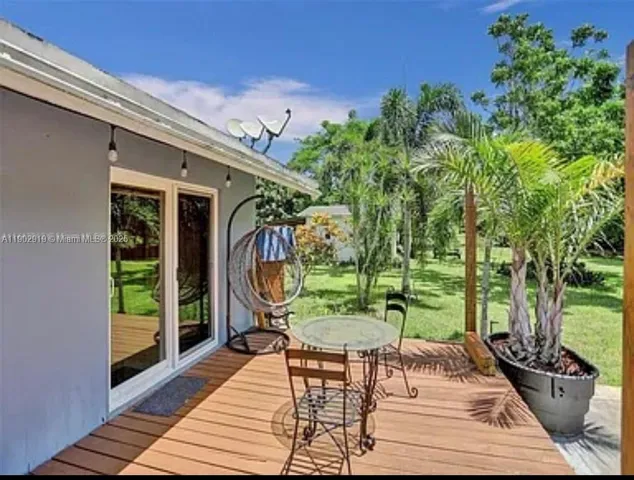 a backyard of a house with barbeque oven table and chairs