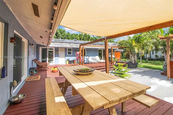 a kitchen with stainless steel appliances granite countertop a sink counter space and a view of living room