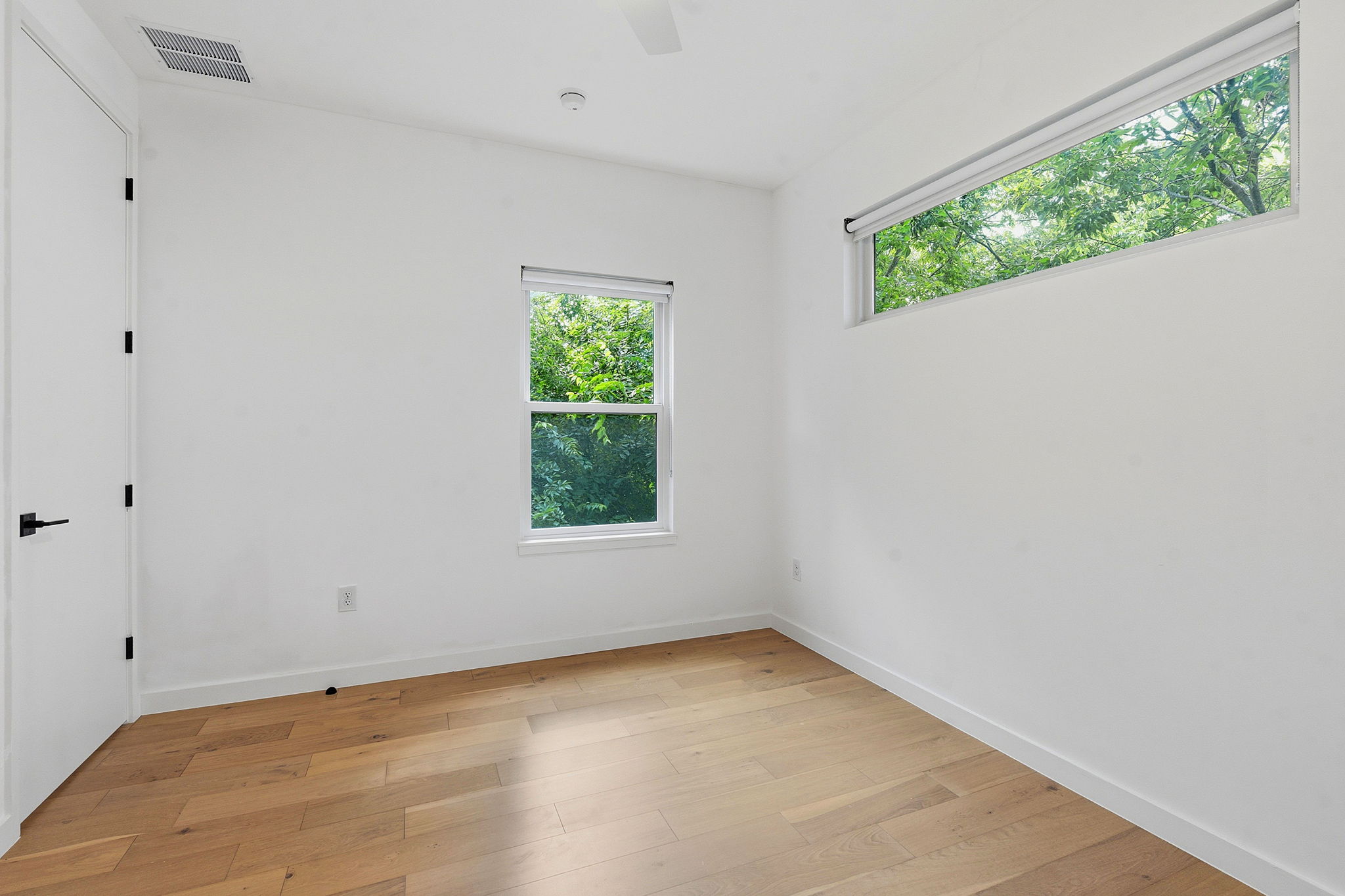 1707 Deloney Street, Unit 2 Austin, TX 78721 - Photo 20 of 26 Hardwood floors and generous windows elevate this bright, adaptable space.