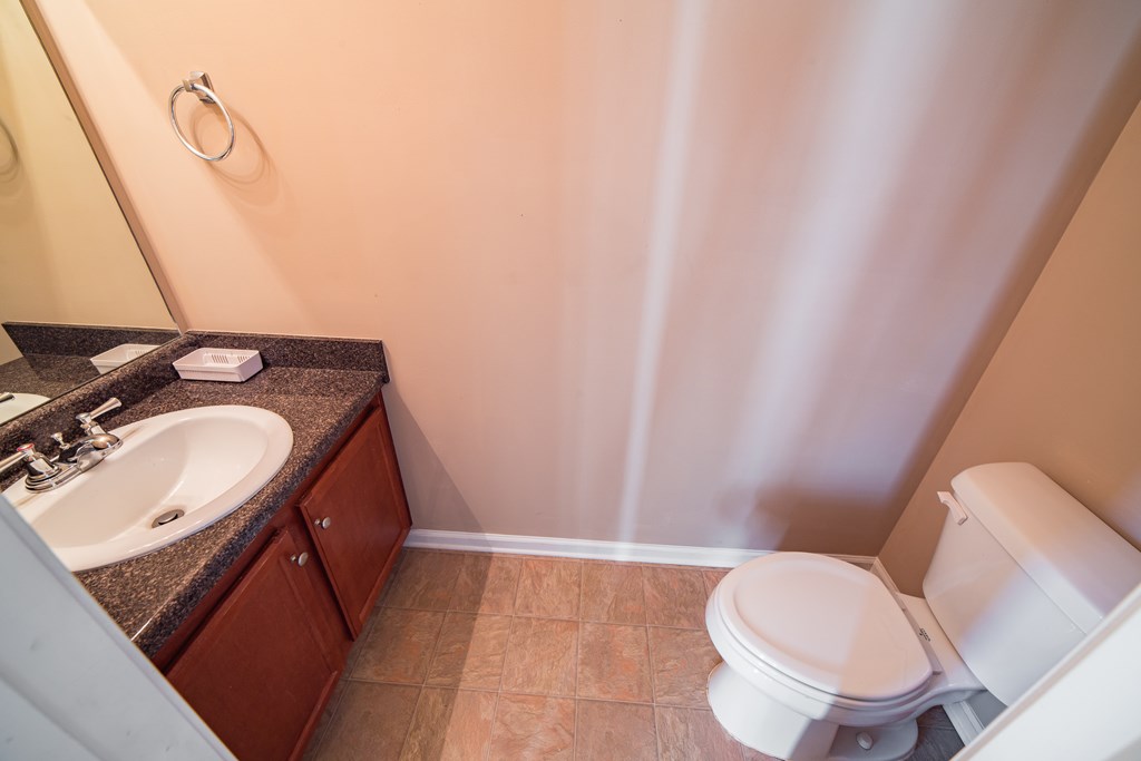 45 Apache Trail Fort Mitchell, AL 36856 - Photo 15 of 43 a bathroom with a granite countertop sink and a mirror