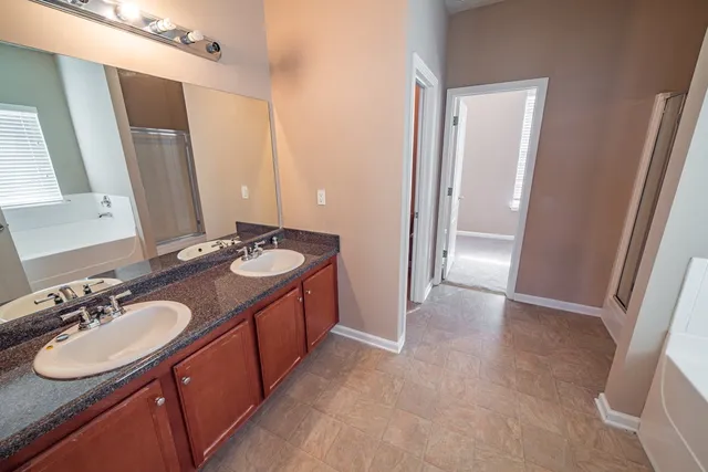 a bathroom with a sink double vanity and a mirror