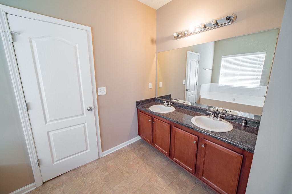 45 Apache Trail Fort Mitchell, AL 36856 - Photo 24 of 43 a bathroom with a granite countertop sink and a mirror