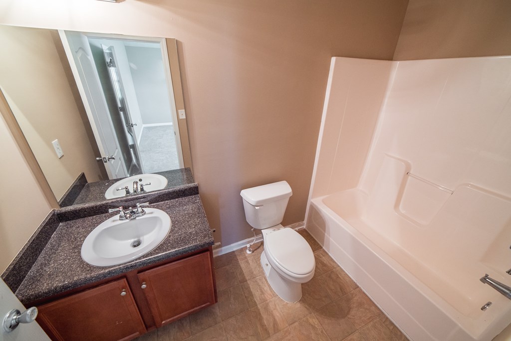 45 Apache Trail Fort Mitchell, AL 36856 - Photo 31 of 43 a bathroom with a granite countertop sink toilet and shower