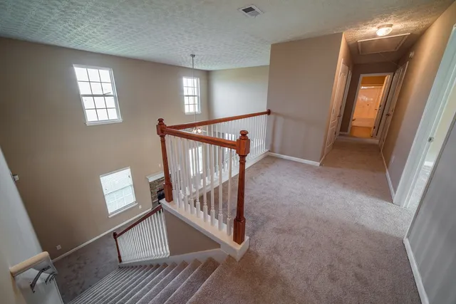 an empty room with fan and windows