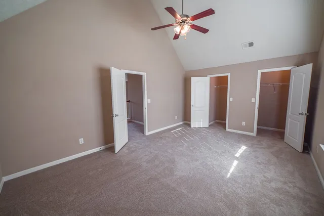 an empty room with closet and a bathroom