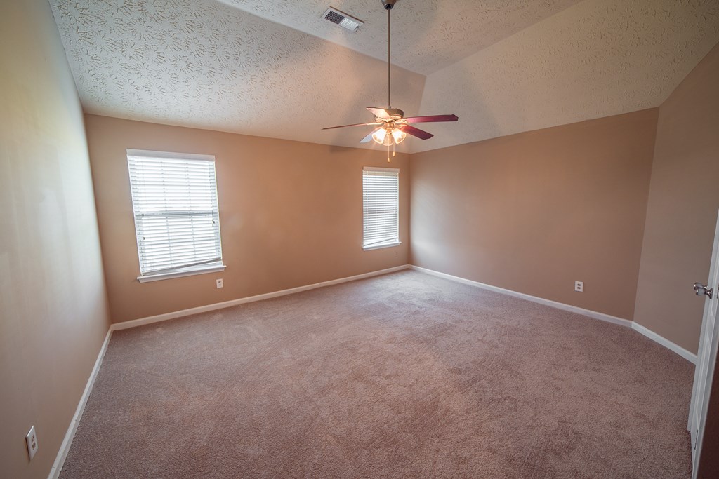 45 Apache Trail Fort Mitchell, AL 36856 - Photo 41 of 43 an empty room with chandelier fan and windows