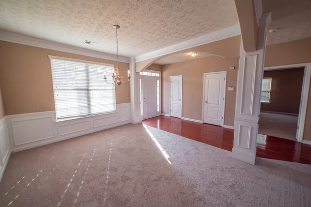 a view of livingroom with hardwood floor and front door