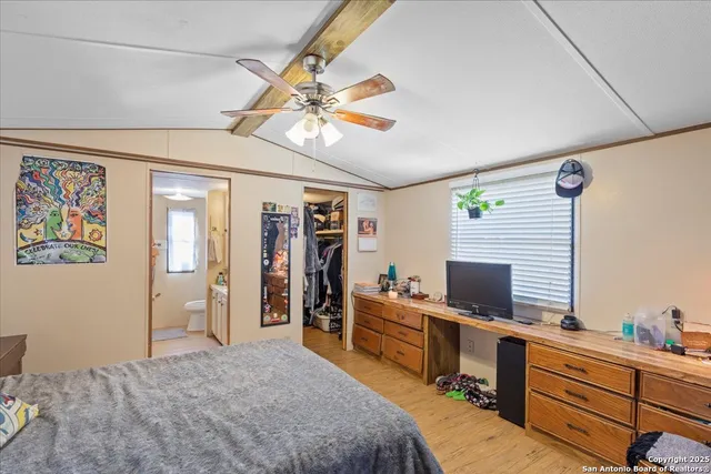 a bedroom with furniture and a window