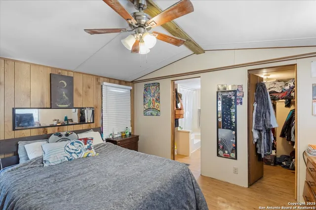 a bedroom with a large bed and a chandelier