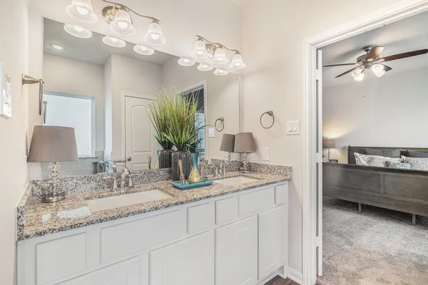 a bathroom with a double vanity sink and mirror