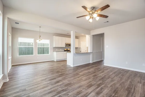 a kitchen with stainless steel appliances granite countertop a stove top oven a sink and a granite counter tops
